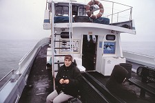 Carol sitting on the boat's aft