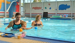 Tommy learns to swim in a pool