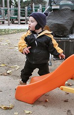 Tom standing near a slide at a mothers' gathering in Berkeley