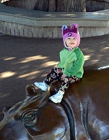 Lisa riding a metallic hippo