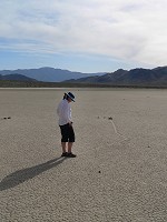 Carol (may be) contemplating secrets of the racing rocks