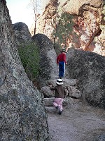 Kids rushing up stairs carved into stone