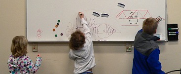 Our kids with a whiteboard at the aquarium