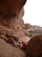 Children have found a hiding place among the boulders inside the Double Arch.