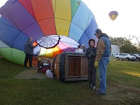 Tom seriously discusses something with pilot Mike during balloon build-up.