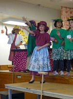 Lisa in her school play, cast as the Red Riding Hood's grandmother.