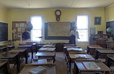 The teacher in this historic classroom seems to be collapsing.