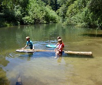 A log is trapped in a pool on San Lorenzo river, and the kids can play with it for hours and hours.