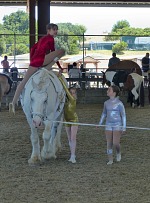 Girls working out with their coach how to re-arrange their free-style for an unfamiliar horse and to fit in an alternate.