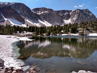 Mirror Lake — in mid-June, snow dominates at ten thousand feet.