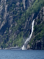 A small cruise ship offers tourists an exclusive shower in Hengjanefossen falls. A small cruise ship offers tourists an exclusive shower in Hengjanefossen falls.